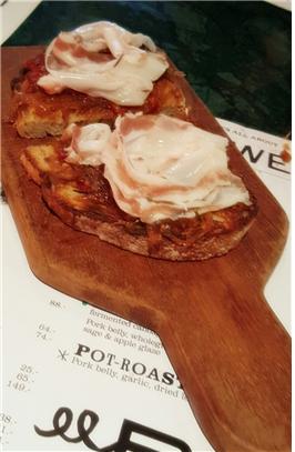 Sliced pork fat, onion marmalade on toast.